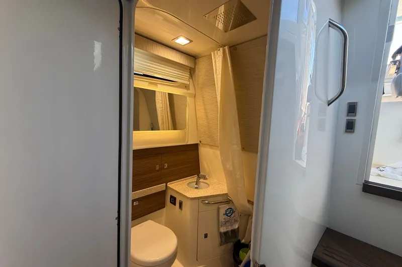 Slide: The Image of 2024 Boston Whaler 420 Outrage bathroom interior with modern fixtures and lighting. - 42