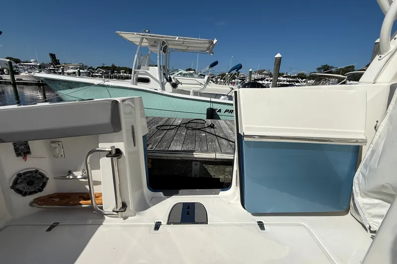 Slide: The Image of 2024 Boston Whaler 420 Outrage at dock, showcasing interior and marina view. - 19