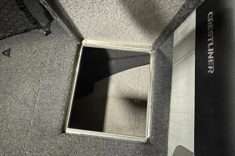 Slide: The Image of Crestliner 1850 Super Hawk 2020 boat interior with open storage compartment. - 16