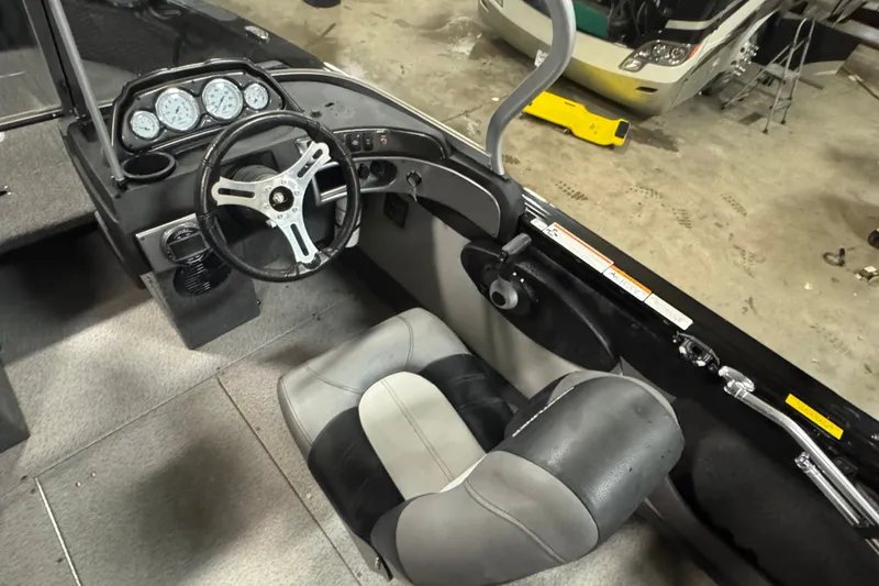 Slide: The Image of 2020 Crestliner 1850 Super Hawk boat interior with steering wheel and dashboard controls. - 8