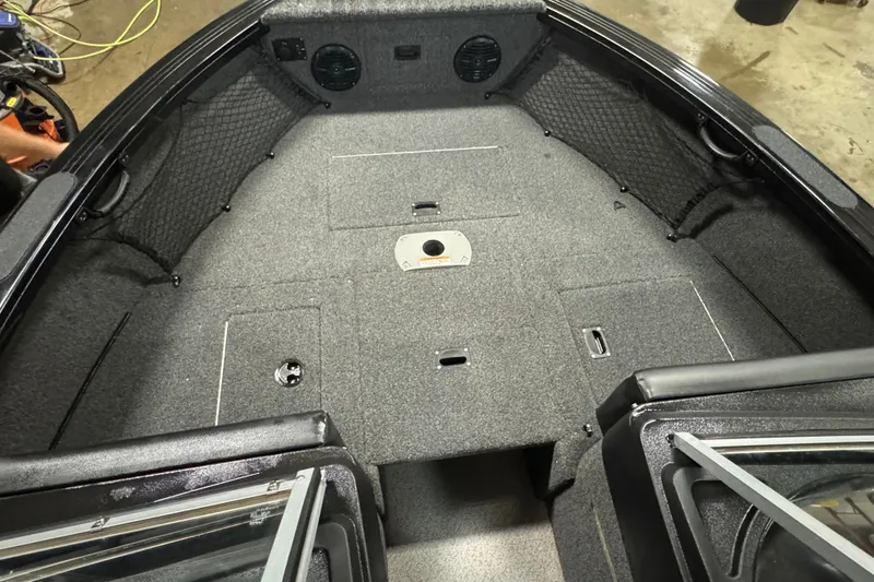 Slide: The Image of 2020 Crestliner 1850 Super Hawk boat interior with spacious, carpeted deck and storage compartments. - 15