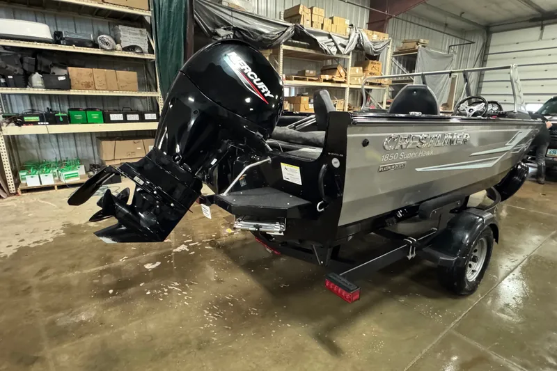 Slide: The Image of 2020 Crestliner 1850 Super Hawk boat with Mercury engine in a warehouse setting. - 3