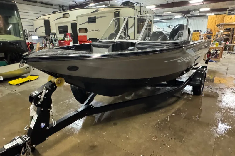 Slide: The Image of 2020 Crestliner 1850 Super Hawk boat on trailer in indoor storage facility. - 1