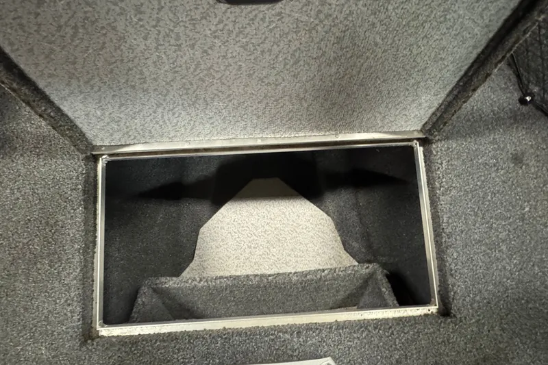 Slide: The Image of Storage compartment of 2020 Crestliner 1850 Super Hawk boat, featuring carpeted interior. - 17