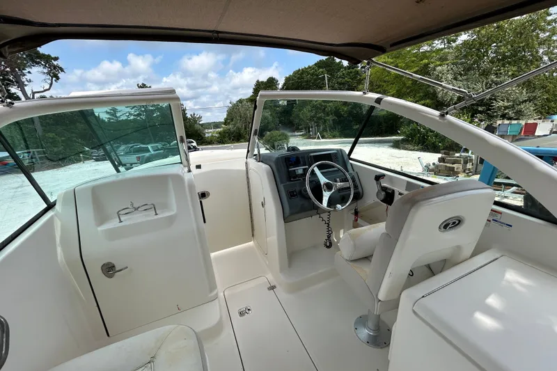 Slide: The Image of 2012 Pursuit DC 265 Dual Console boat interior with steering wheel and seating. - 17