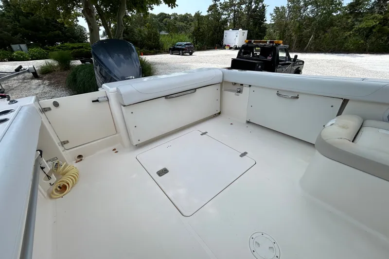 Slide: The Image of 2012 Pursuit DC 265 Dual Console boat interior with seating and storage compartments. - 9