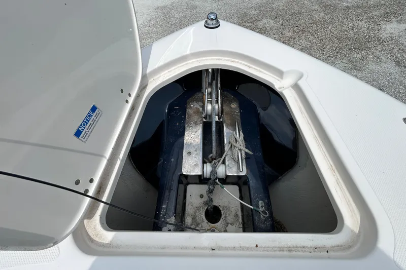 Slide: The Image of Open anchor compartment on a 2012 Pursuit DC 265 Dual Console boat. - 22