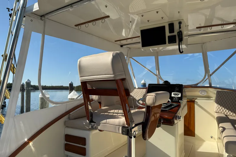 Slide: The Image of Interior view of a 1998 Dorado 36 Express boat cockpit with helm and seating. - 14