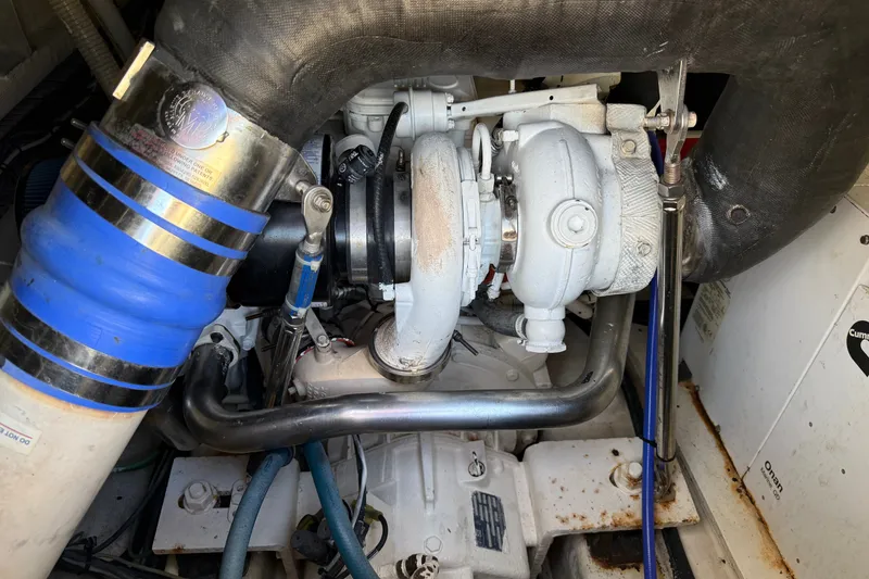 Slide: The Image of Engine compartment of a 1998 Dorado 36 Express boat, featuring visible turbocharger components. - 51