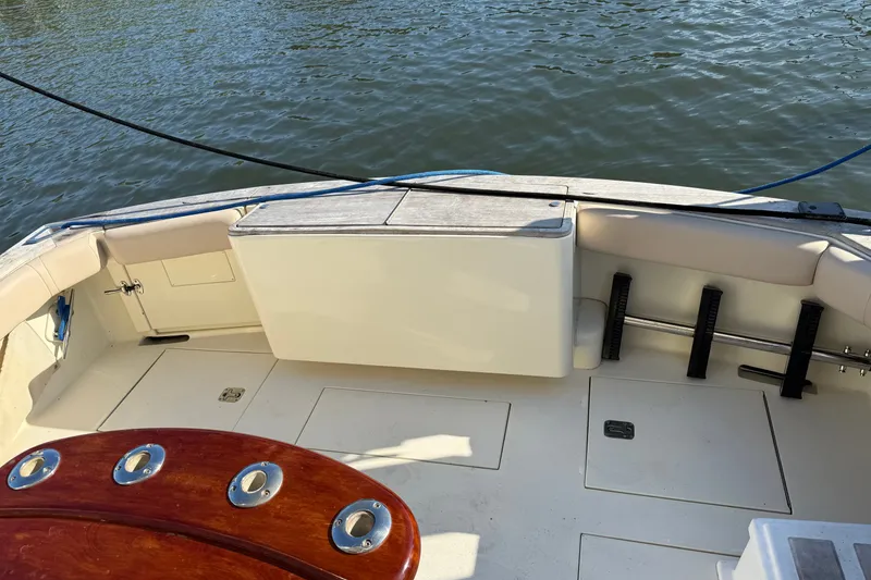 Slide: The Image of 1998 Dorado 36 Express boat deck with seating and fishing rod holders. - 52