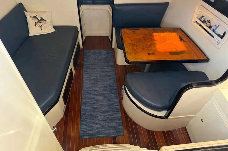Slide: The Image of Interior of 1998 Dorado 36 Express boat with seating and nautical-themed table. - 28