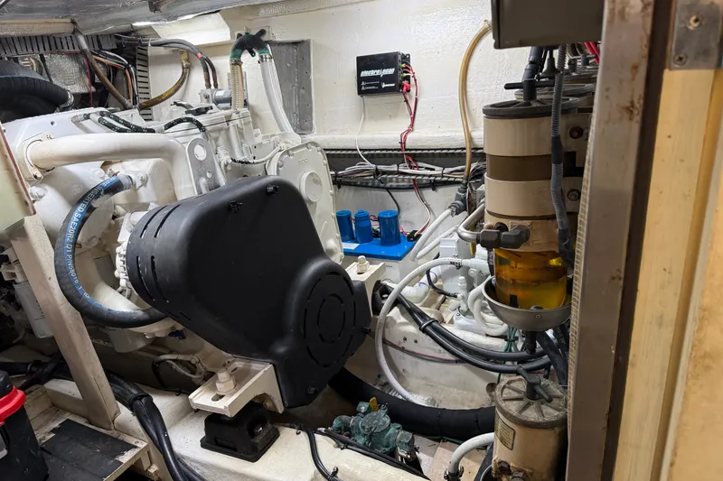 Slide: The Image of Engine room of a 1998 Dorado 36 Express boat, showcasing mechanical components and wiring. - 49