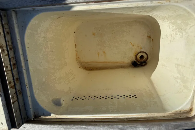 Slide: The Image of Open storage compartment on a 1998 Dorado 36 Express boat, showing interior details. - 54