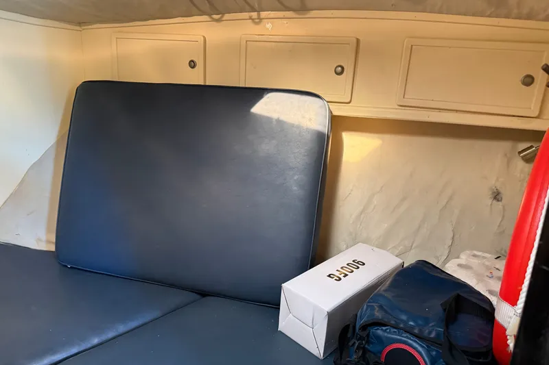 Slide: The Image of Interior cabin of 1998 Dorado 36 Express boat with storage cabinets and seating. - 32