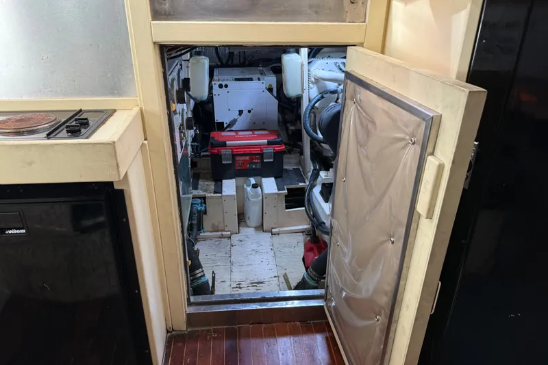 Slide: The Image of Engine room of a 1998 Dorado 36 Express boat with visible equipment and tools. - 46