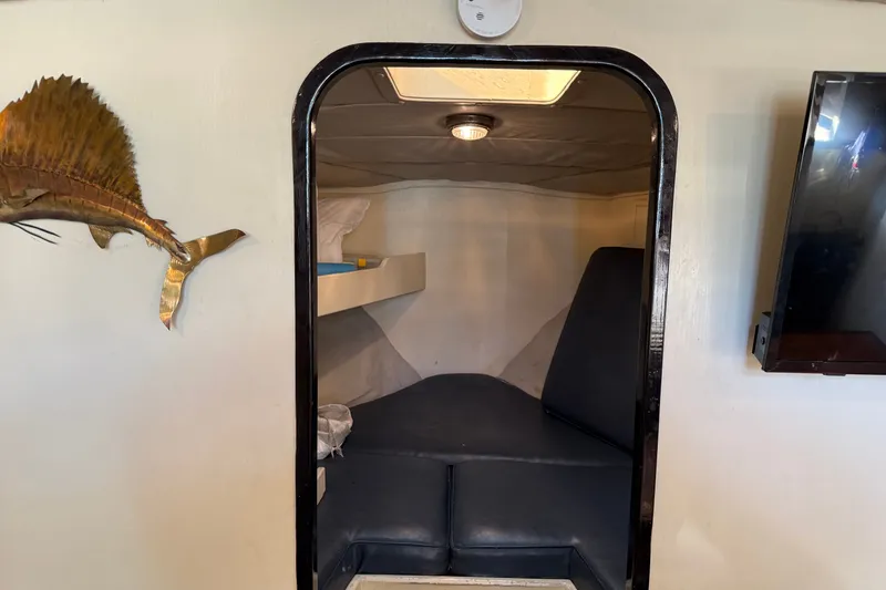 Slide: The Image of Interior cabin of 1998 Dorado 36 Express boat with cozy seating and wall decor. - 30