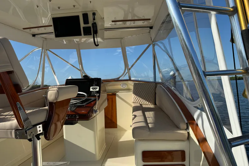 Slide: The Image of Interior of a 1998 Dorado 36 Express boat with helm and seating area. - 13