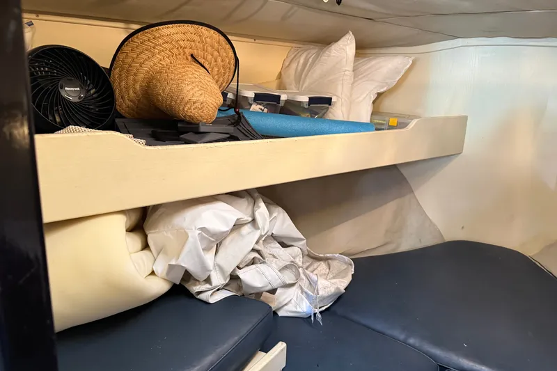 Slide: The Image of Interior cabin storage of 1998 Dorado 36 Express with fan, hat, and cushions. - 31