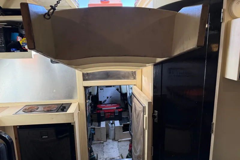 Slide: The Image of Interior of a 1998 Dorado 36 Express boat showing kitchen and engine room access. - 45