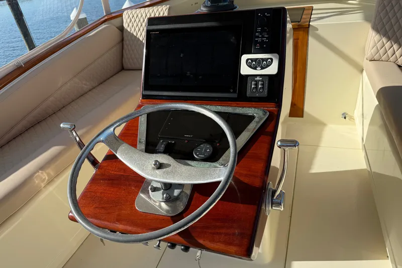 Slide: The Image of Steering console of a 1998 Dorado 36 Express boat with wooden accents. - 17