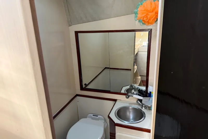 Slide: The Image of Bathroom interior of 1998 Dorado 36 Express boat with mirror, sink, and toilet. - 39