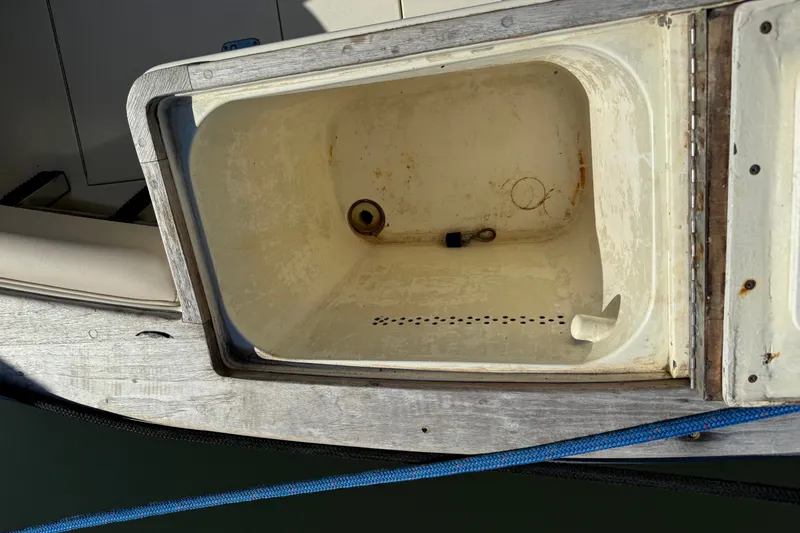 Slide: The Image of Open storage compartment on a 1998 Dorado 36 Express boat, showing interior details. - 53