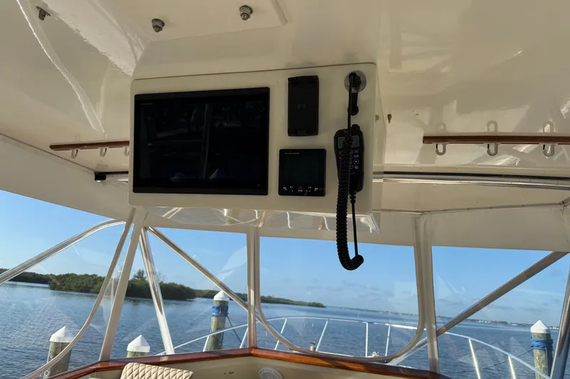 Slide: The Image of Interior view of 1998 Dorado 36 Express boat with navigation equipment and scenic water backdrop. - 18