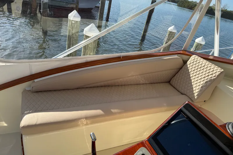 Slide: The Image of Luxurious seating on a 1998 Dorado 36 Express boat, docked by the water. - 21