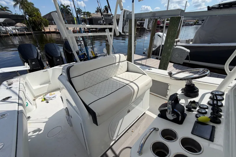 Slide: The Image of 2006 Yellowfin 36 Offshore boat interior with seating, steering wheel, and fishing equipment. - 16