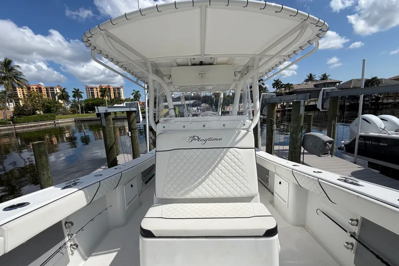 Slide: The Image of 2006 Yellowfin 36 Offshore boat docked, featuring spacious seating and sleek design. - 9