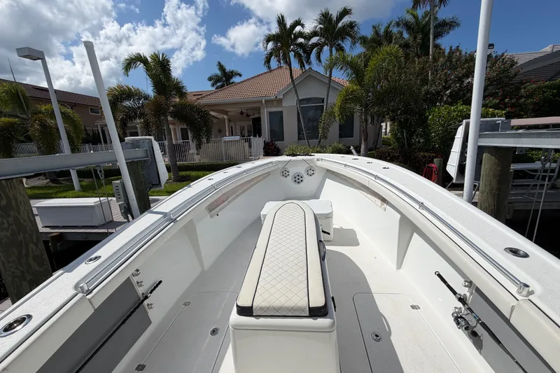 Slide: The Image of 2006 Yellowfin 36 Offshore boat docked near a tropical house with palm trees. - 11