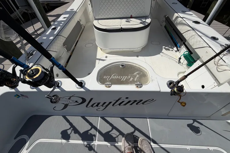 Slide: The Image of 2006 Yellowfin 36 Offshore boat deck with fishing rods and seating area. - 19