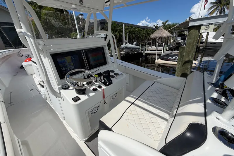 Slide: The Image of 2006 Yellowfin 36 Offshore boat cockpit with steering wheel and navigation screens. - 13