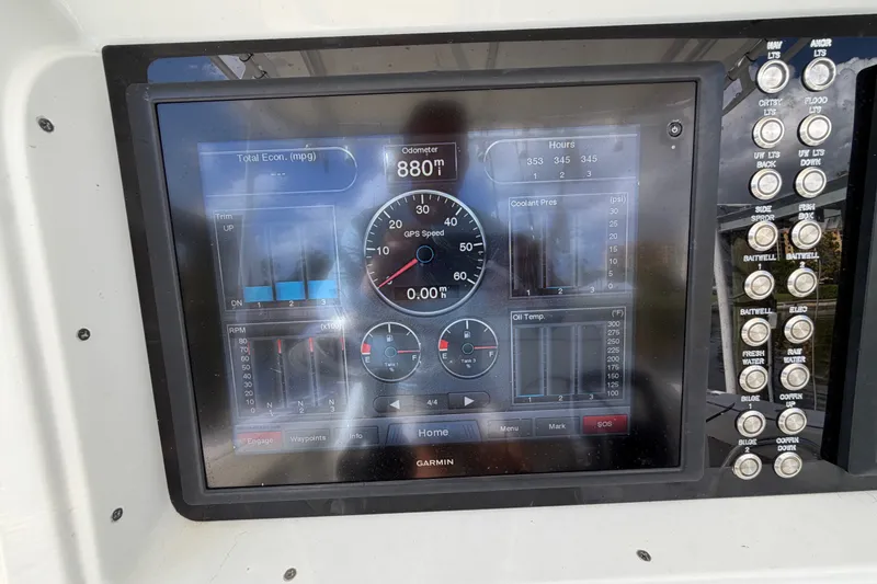 Slide: The Image of Garmin marine display on 2006 Yellowfin 36 Offshore boat dashboard, showing various engine metrics. - 20