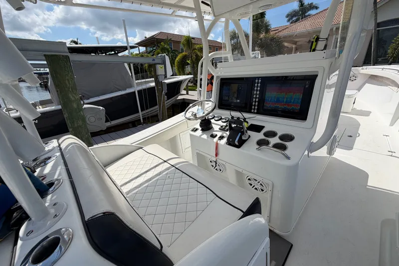 Slide: The Image of 2006 Yellowfin 36 Offshore boat cockpit with modern navigation equipment and seating. - 14