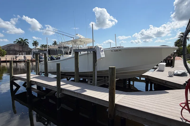 The Image of 2006 Yellowfin 36 Offshore boat docked on a sunny day with palm trees. - 0