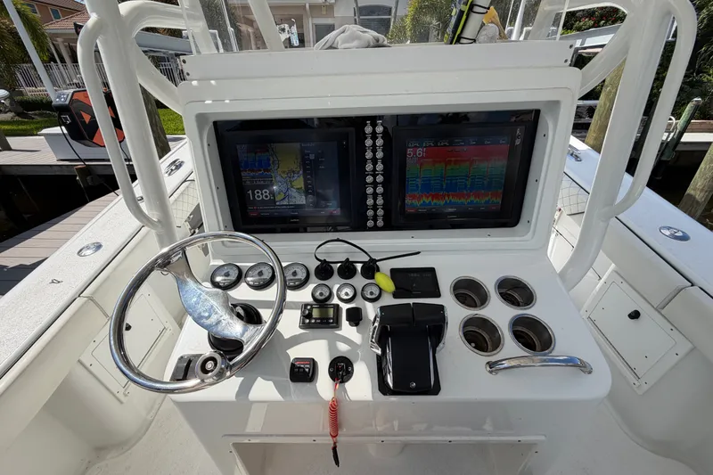 Slide: The Image of 2006 Yellowfin 36 Offshore boat dashboard with navigation screens and controls. - 12