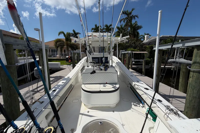 Slide: The Image of 2006 Yellowfin 36 Offshore boat docked, equipped with fishing rods and gear. - 18