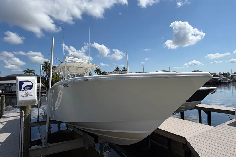 Slide: The Image of 2006 Yellowfin 36 Offshore boat docked under a clear blue sky. - 4