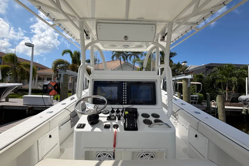 Slide: The Image of 2006 Yellowfin 36 Offshore boat cockpit with navigation system, docked under clear blue sky. - 15