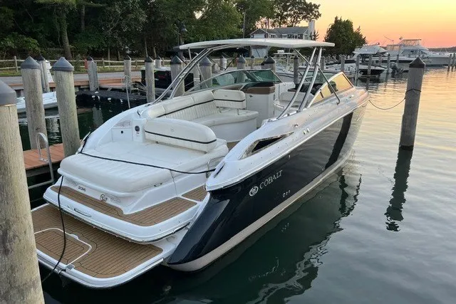 The Image of 2016 Cobalt 336 boat docked at sunset, featuring sleek design and spacious seating. - 0