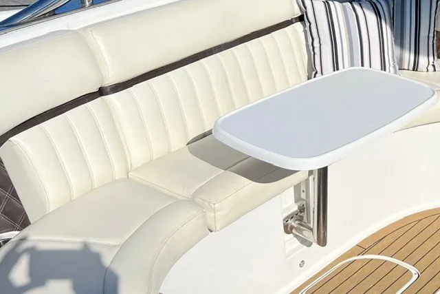 Slide: The Image of Luxurious seating area on a 2016 Cobalt 336 boat with a sleek white table. - 10
