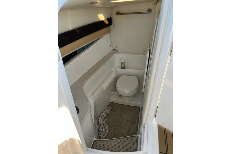 Slide: The Image of Compact bathroom inside 2016 Cobalt 336 boat, featuring toilet and storage space. - 6