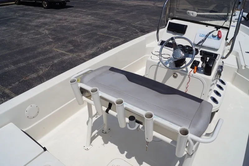 Slide: The Image of 2025 Skeeter SX2250 boat interior with steering console and rod holders. - 9