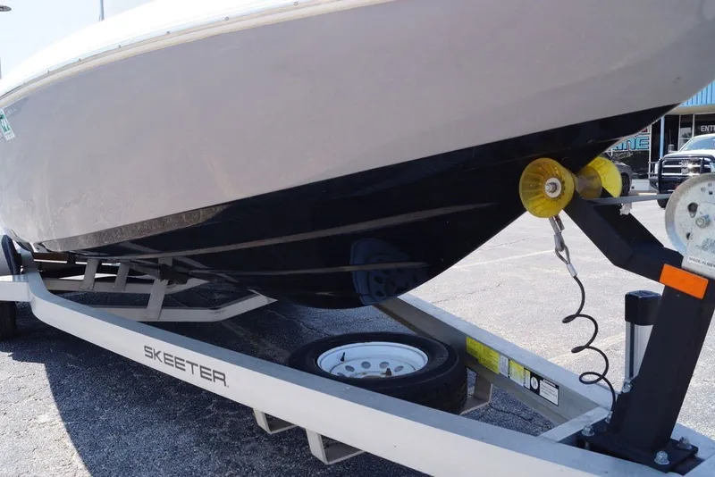 Slide: The Image of 2025 Skeeter SX2250 boat on trailer, close-up view of hull and winch. - 5