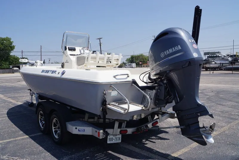 Slide: The Image of 2025 Skeeter SX2250 boat with Yamaha outboard motor on trailer in parking lot. - 12