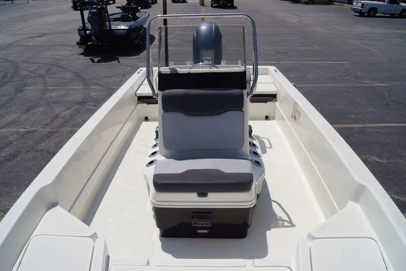 Slide: The Image of 2025 Skeeter SX2250 boat interior with seating and console, parked in a lot. - 16