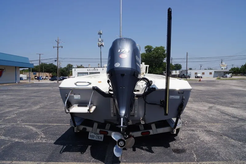 Slide: The Image of 2025 Skeeter SX2250 boat with outboard motor on a trailer in a parking lot. - 7