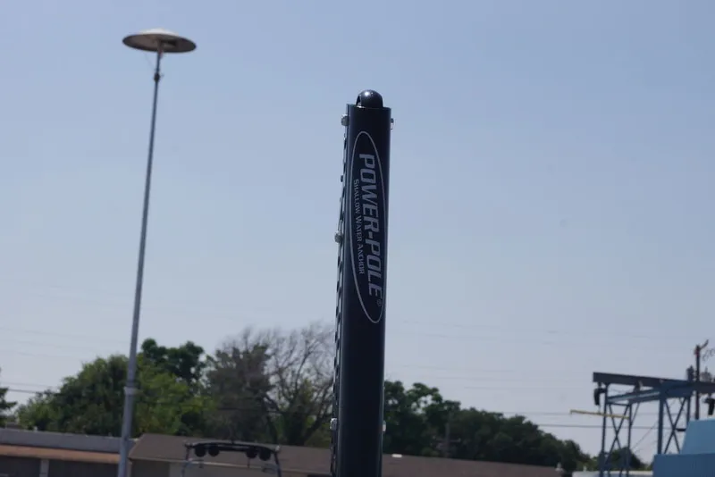 Slide: The Image of Power-Pole anchor on 2025 Skeeter SX2250 boat against clear sky. - 13
