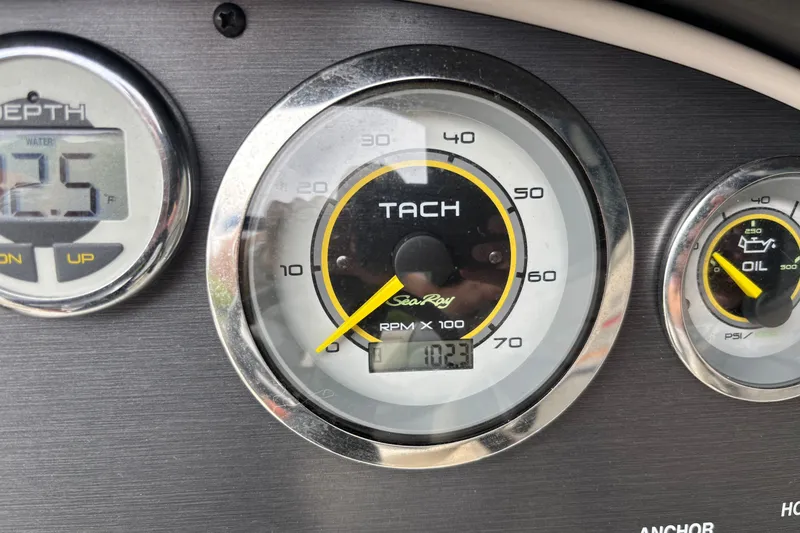 Slide: The Image of Dashboard gauges of a 2010 Sea Ray 185 Sport boat, showing tachometer and depth. - 5